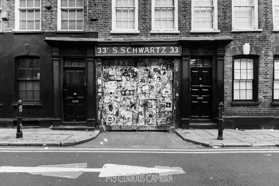 S Schwartz Building 33A Fournier Street, Spitalfields London showing the entrance covered in posters