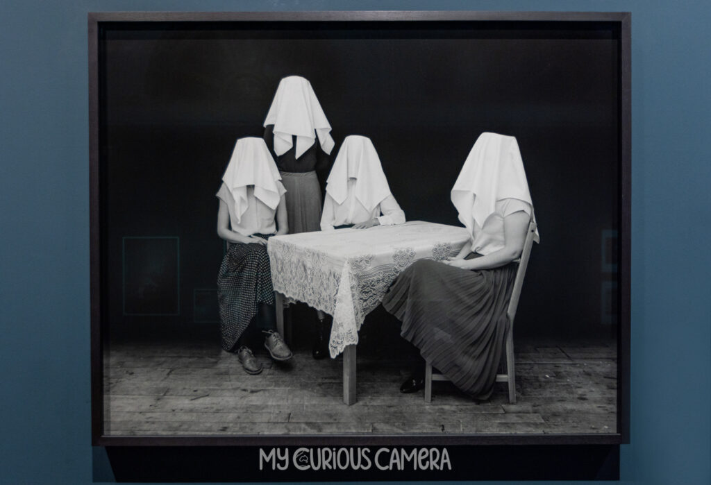 Unseen by Tereza Zelenková a family sitting at the table with towels on their heads
