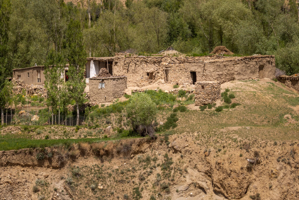 A local Afghan home sitting on the rocky cliffs at the edge of the Panj River